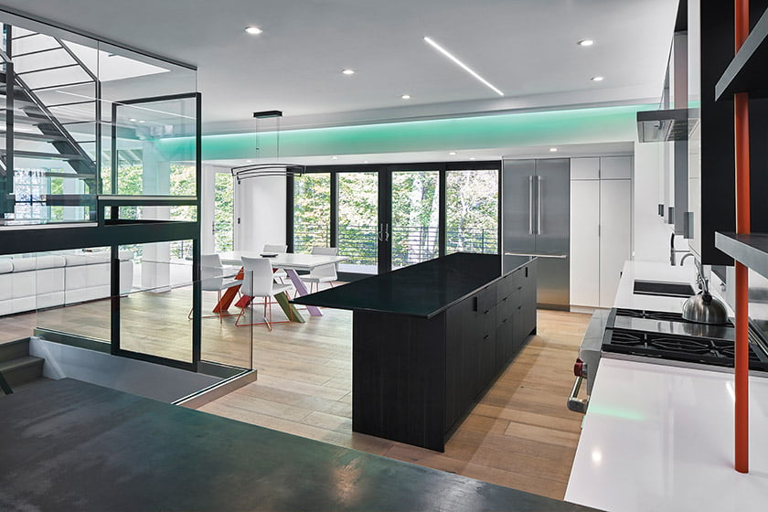 The open-plan main floor, featuring color-changing LED lights, spills out to the deck through sets of glass doors.