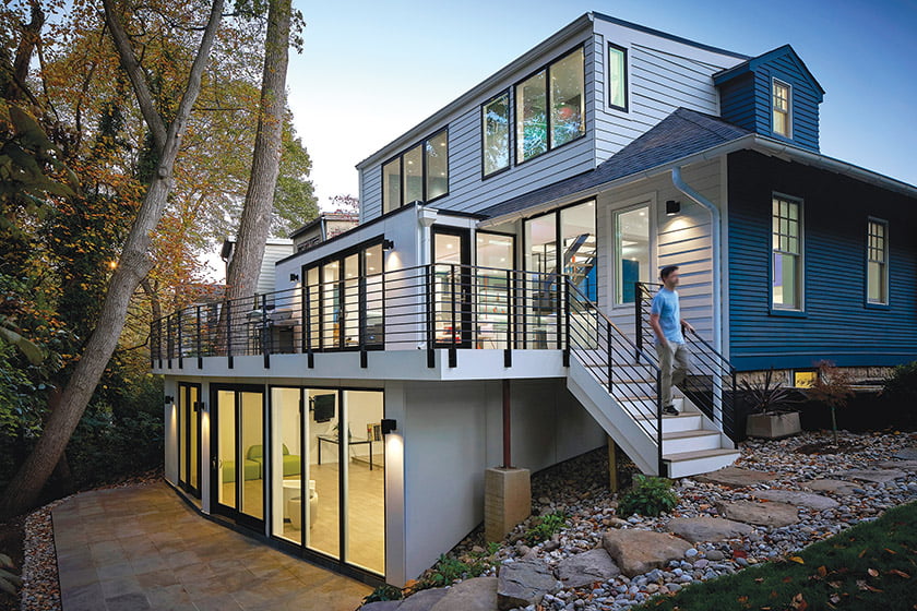 The open-plan main floor, featuring color-changing LED lights, spills out to the deck through sets of glass doors.