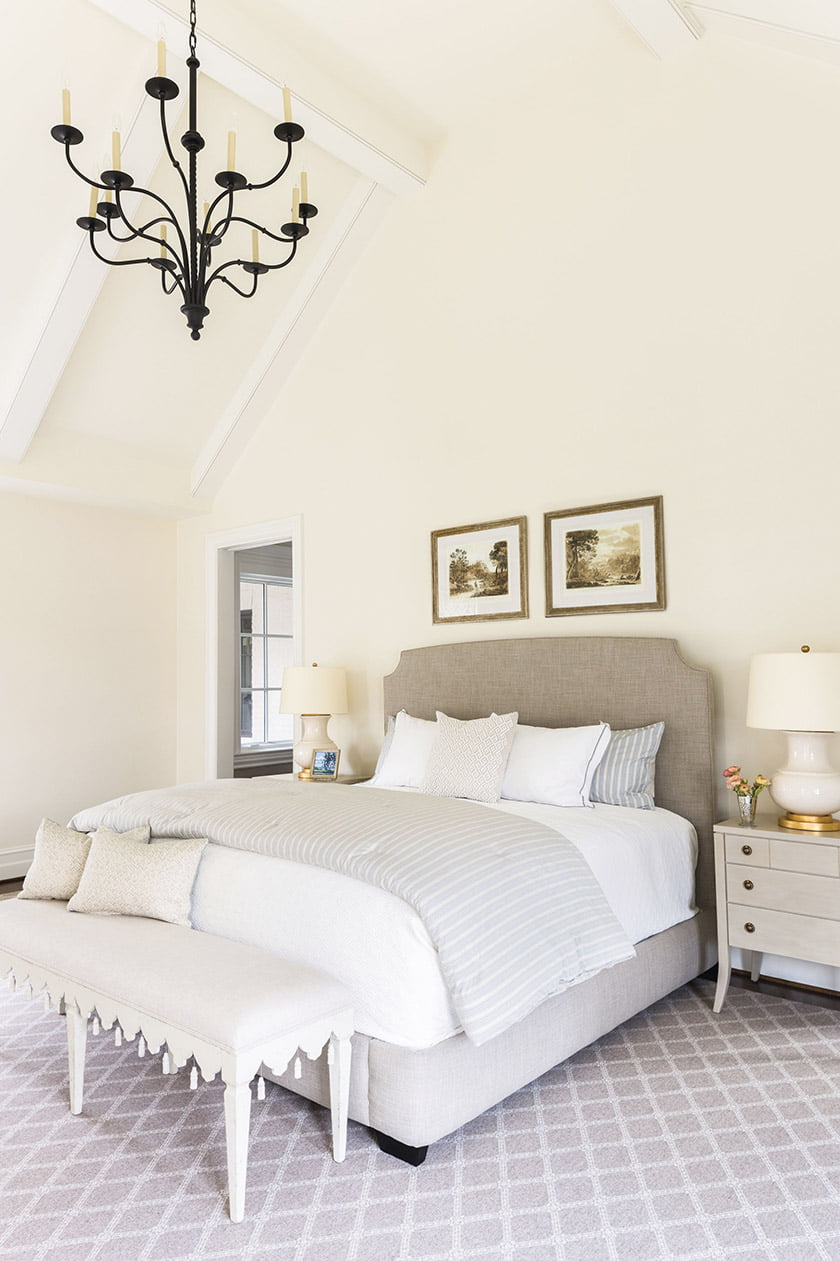 In the bedroom, hand-painted nightstands from Tritter Feefer flank a Serena & Lily bed.