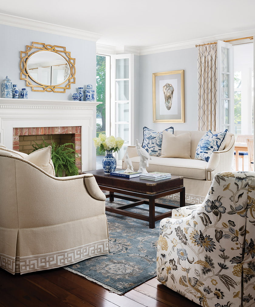 A Loloi rug grounds the living room, where vintage loveseats sit beside Wesley Hall chairs.