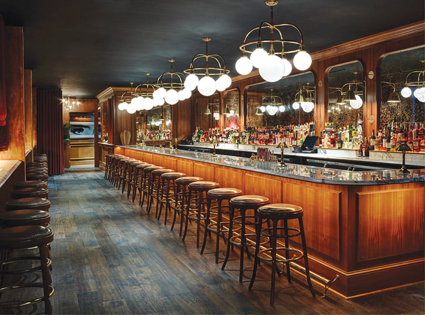 The marble-topped bar is illuminated by fanciful fixtures. Photo: Richard Powers