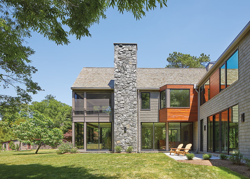 A fieldstone chimney adds drama to the two-story contemporary farmhouse.