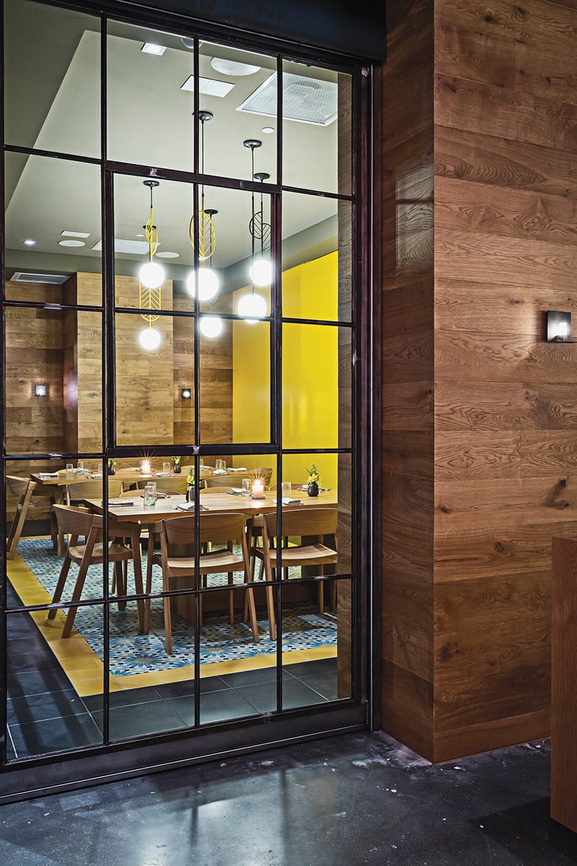 Grupo7 designed the modern interior with distressed-wood paneling and colorful tilework. Photo: Scott Suchman