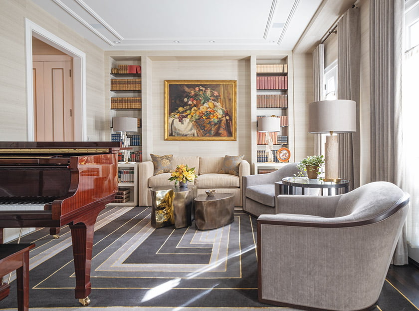 The library sports a mod, geometric carpet from The Rug Company and bronze coffee tables by Silas Seandel.