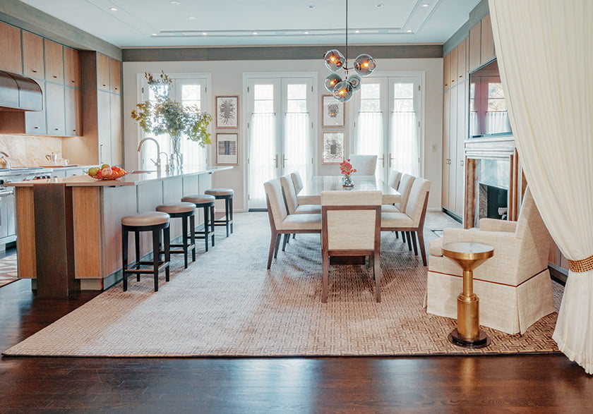 In the new kitchen and dining area, oak cabinetry banded with gray accents flanks the Keith Fritz table.