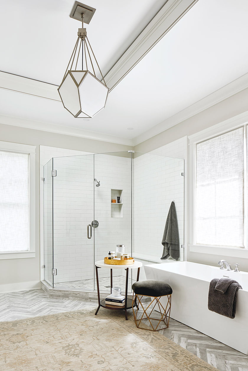 An Oushak rug softens the marble-tiled floor in the owners' bathroom.