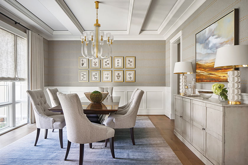 Phillip Jeffries wall covering embellished with gold studs graces the dining room.