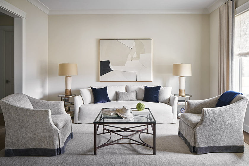In the living room, antique-gold Arteriors tables and a Joelle Somero painting invigorate the neutral palette.
