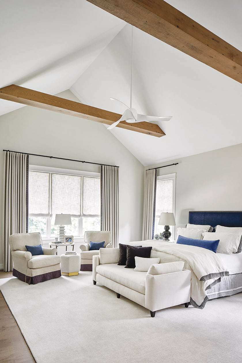 A Lee Industries bed and a bench from Cisco Brothers Furniture anchor the owners' suite.
