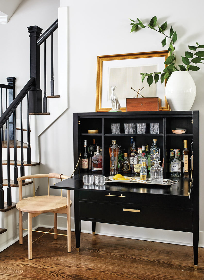 A bar cabinet from AVE is paired with an Iatesta vase and a Gene Davis lithograph.