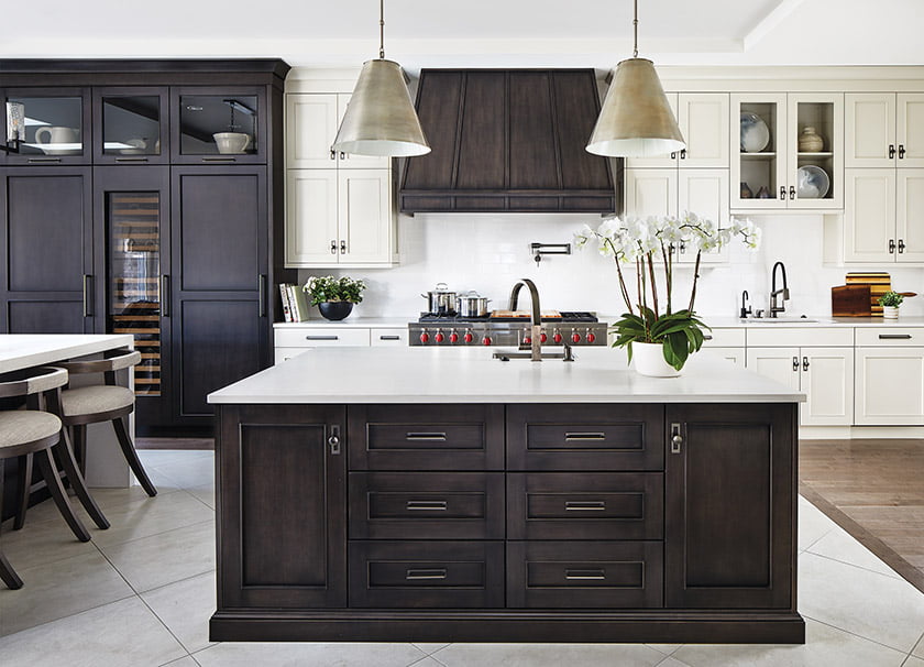 White-painted cabinetry and white Caesarstone countertops are offset by glazed