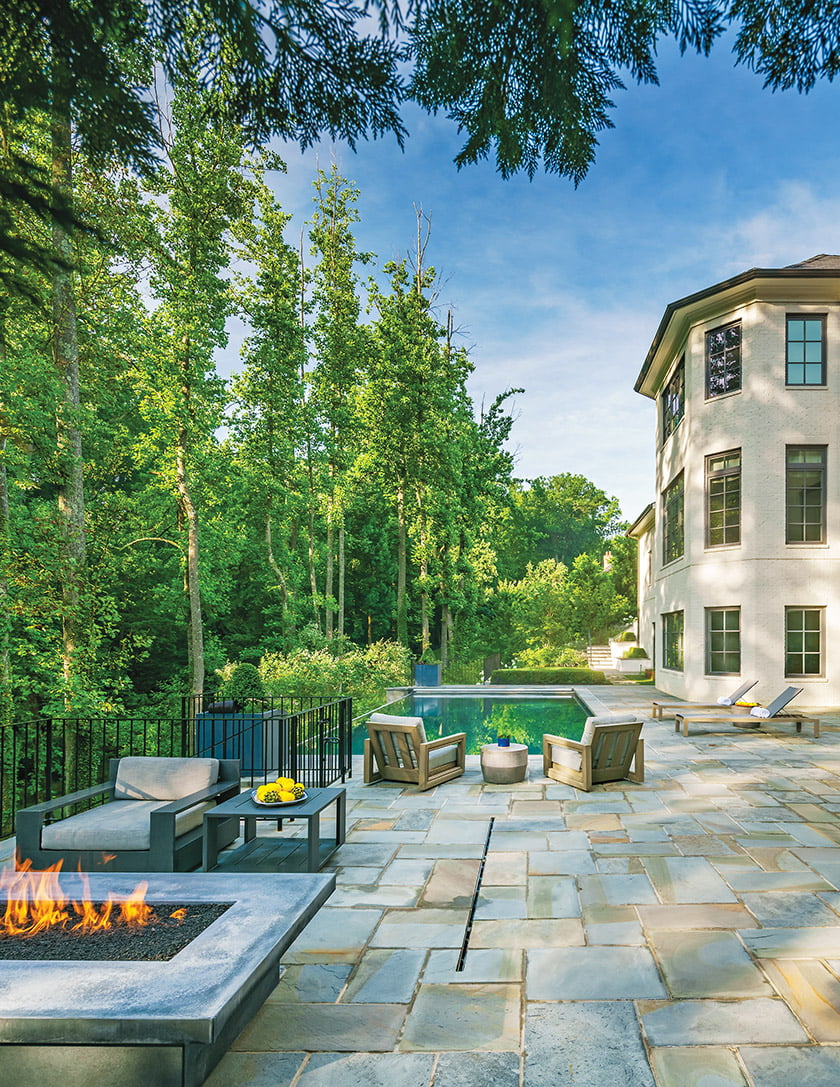 Stairway leads to backyard lawn pool and fire pit