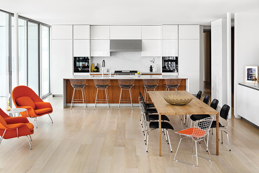 Open kitchen features white-lacquer and walnut cabinetry from Snaidero