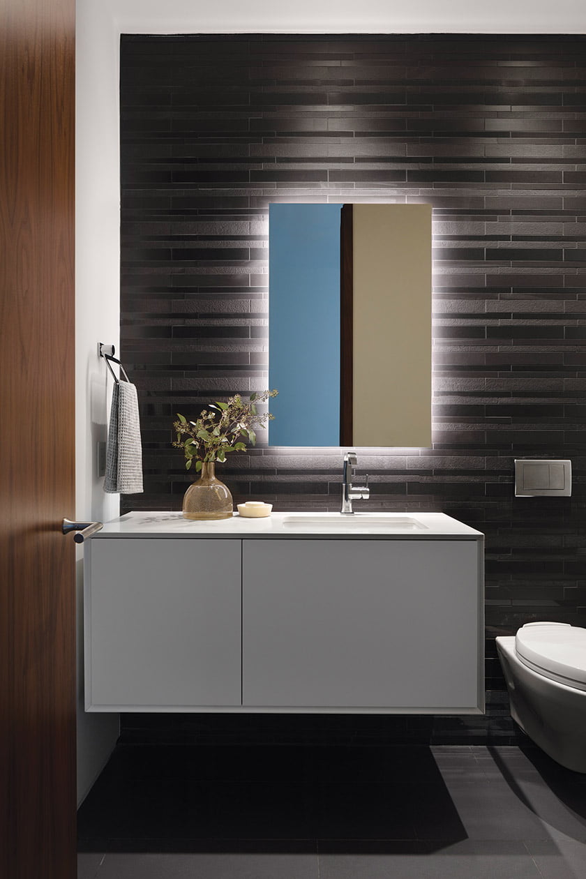 Powder room features Daltile’s Unity porcelain tile in Nero and Grohe faucet