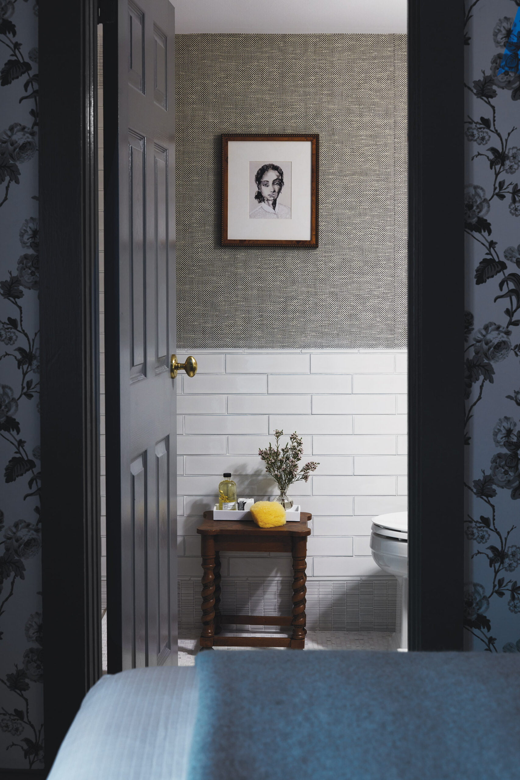 En-suite bath with Schumacher wallpaper and Ann Sacks subway and ribbed-mosaic base tile.