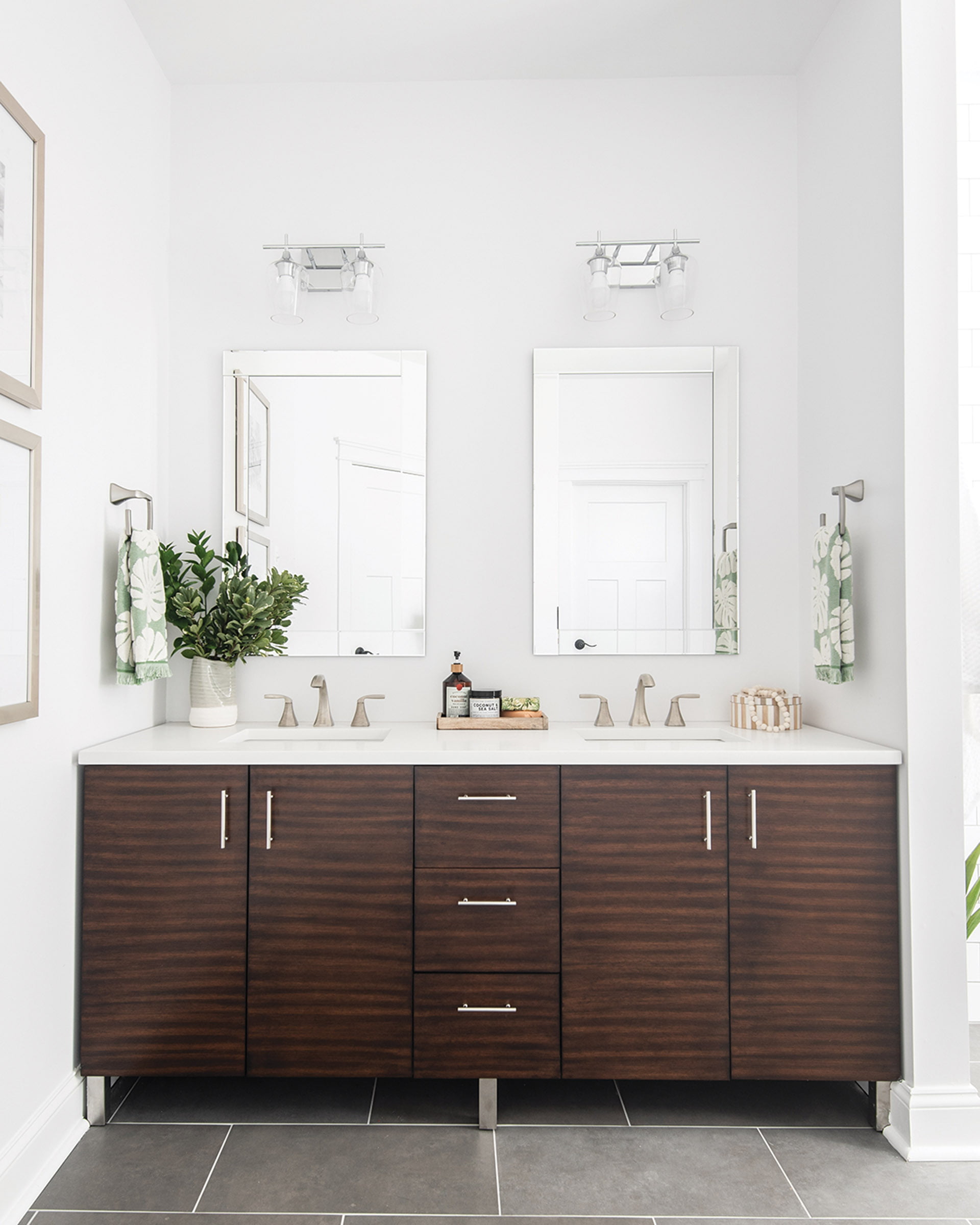 Bath boasts a wooden vanity  and a porcelain floor