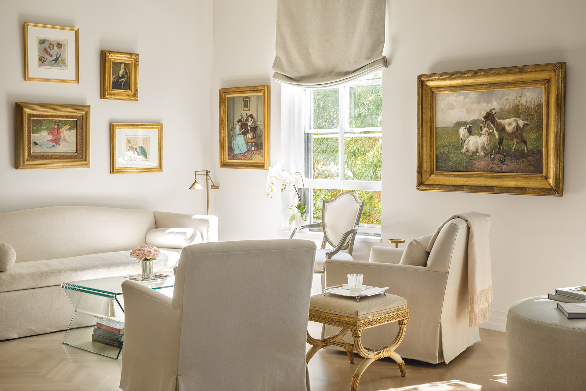 Martens grouped small, gilt-framed paintings salon-style on the wall above a Ferrell Mittman sofa in living area