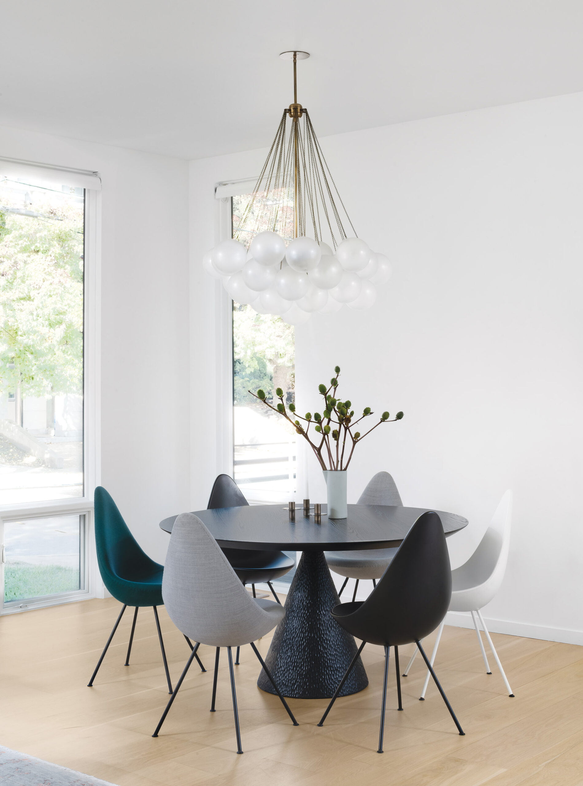 Dining room table and Arne Jacobsen Drop chairs upholstered in Kvadrat fabrics from Furniture From Scandinavia; an Apparatus chandelier