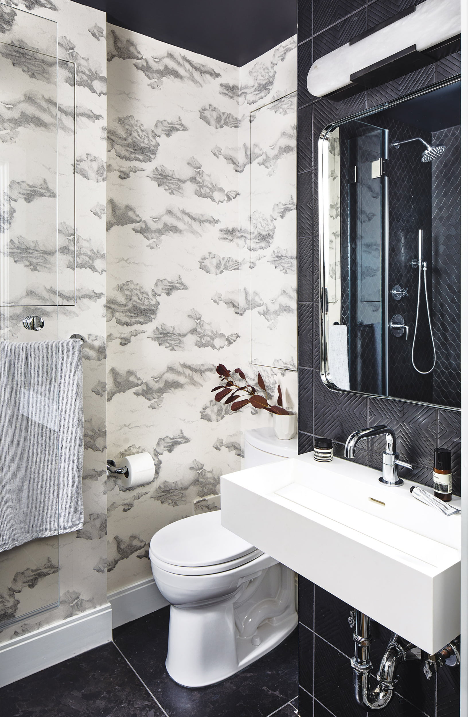 Black-and-white powder room, Harlequin wallpaper and textured, geometric wall tile from Ann Sacks