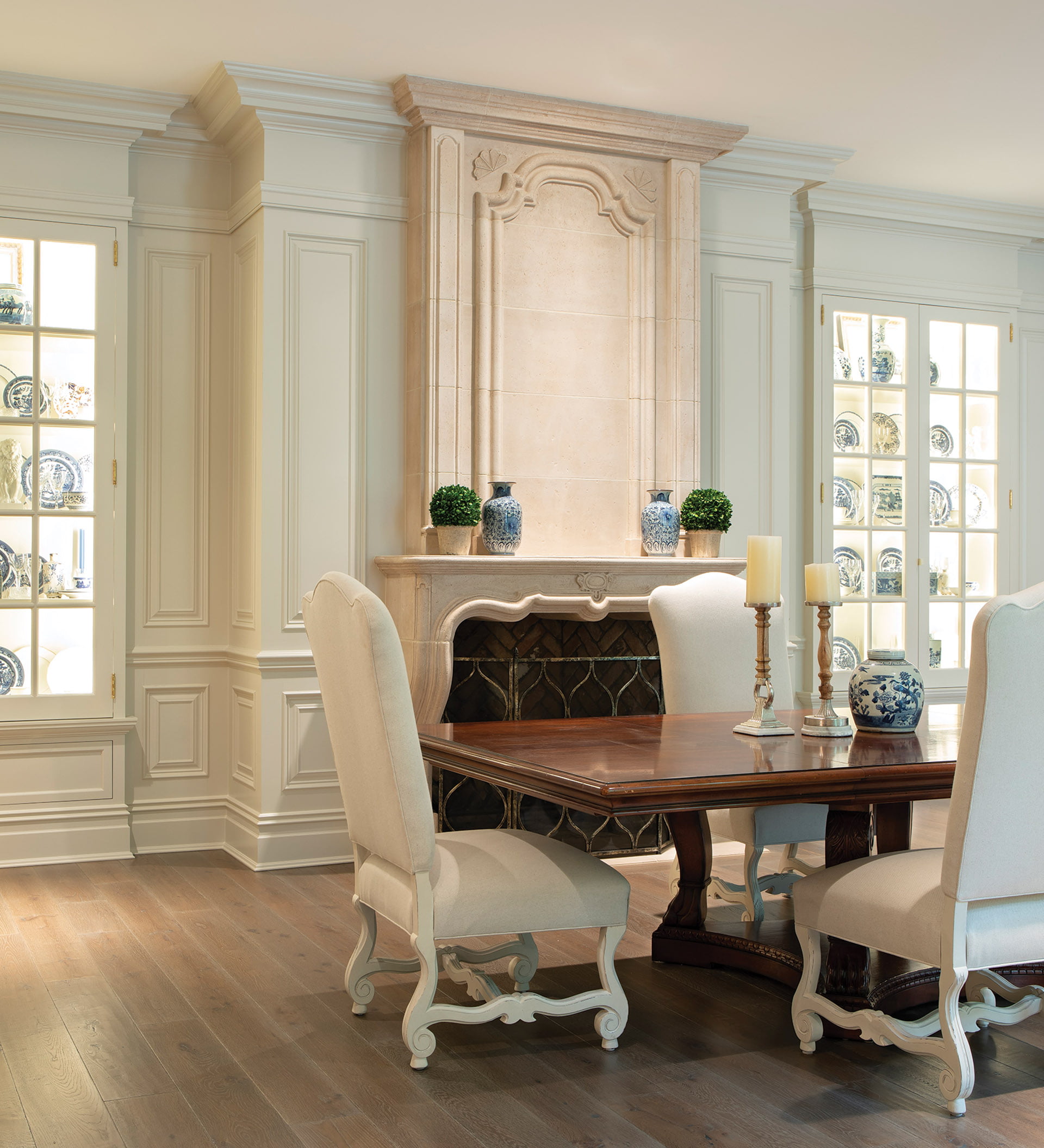Dining room displays china collection in glass-fronted cabinets.