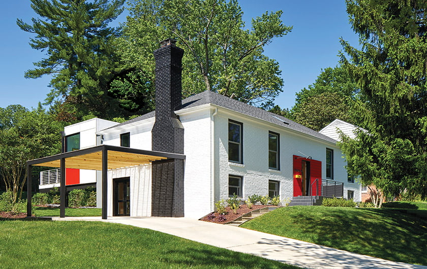 Red panels frame the front door of a bi-level remodeled by Richard Loosle-Ortega of KUBE Architecture