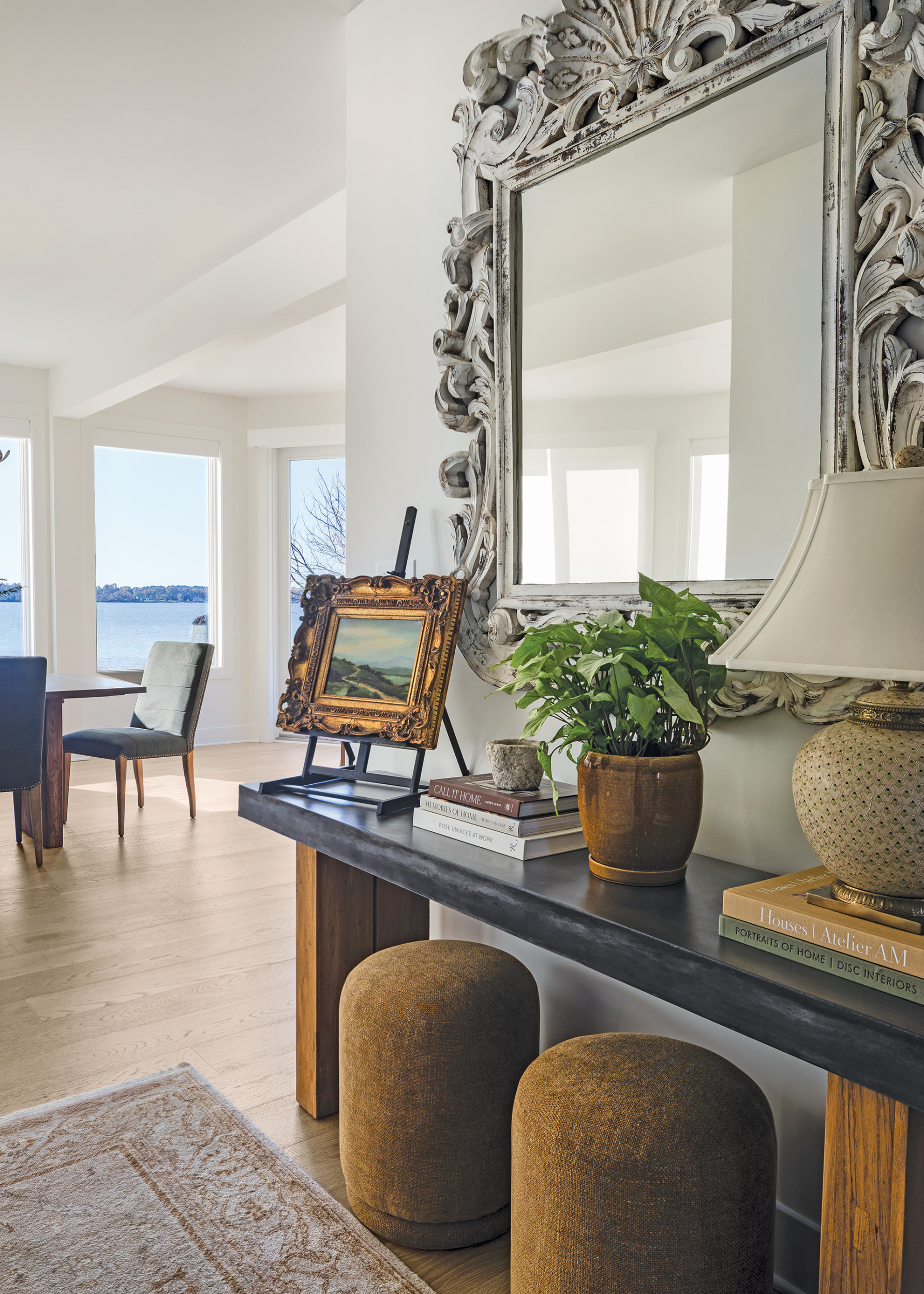 Entry with RH console table, vintage mirror, and Oriental rug | Home and Design Magazine