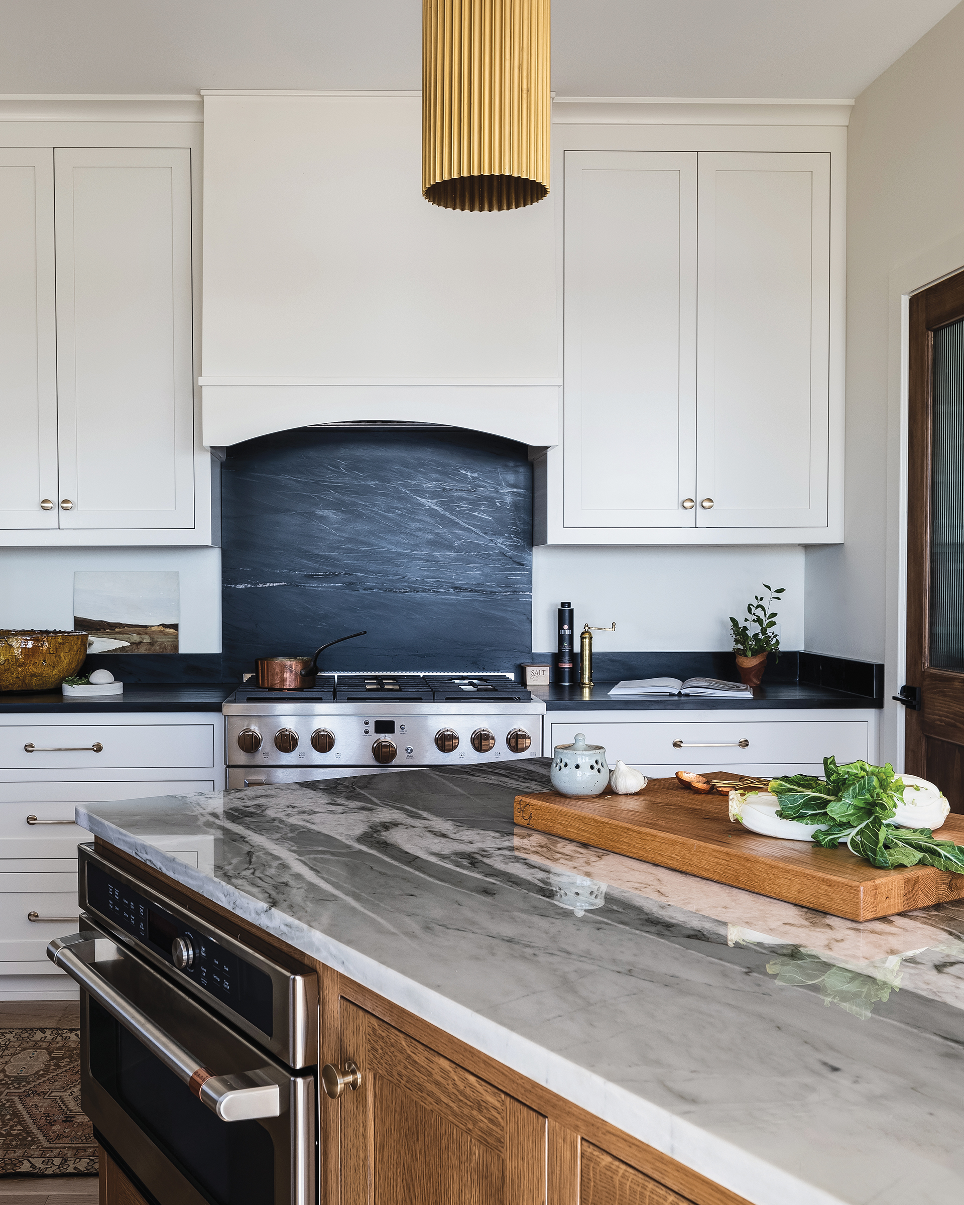 Soapstone backsplash and counters with color-changing quartzite island top | Home and Design Magazine