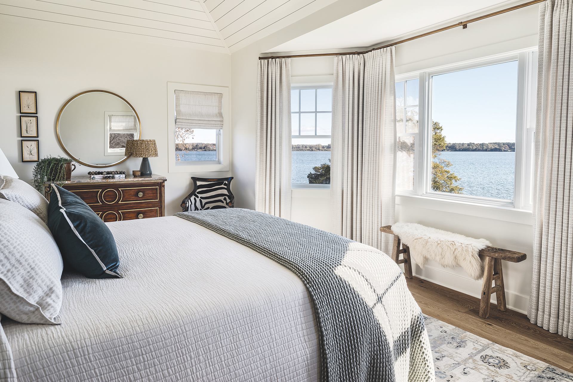 Primary bedroom with vintage dresser and zebra-patterned chair | Home and Design Magazine
