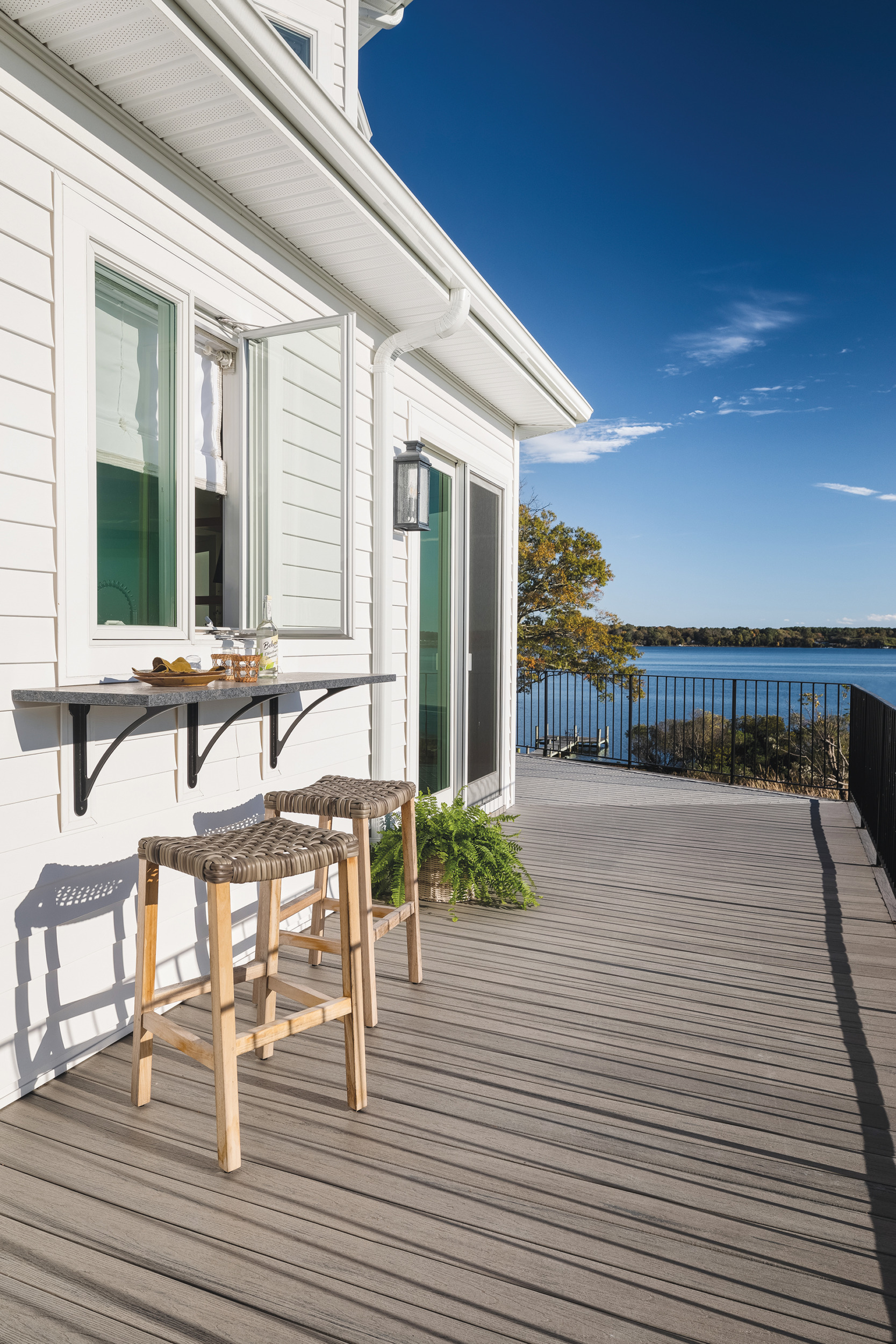 Wraparound deck with snack bar and casement windows opening to the kitchen | Home and Design Magazine