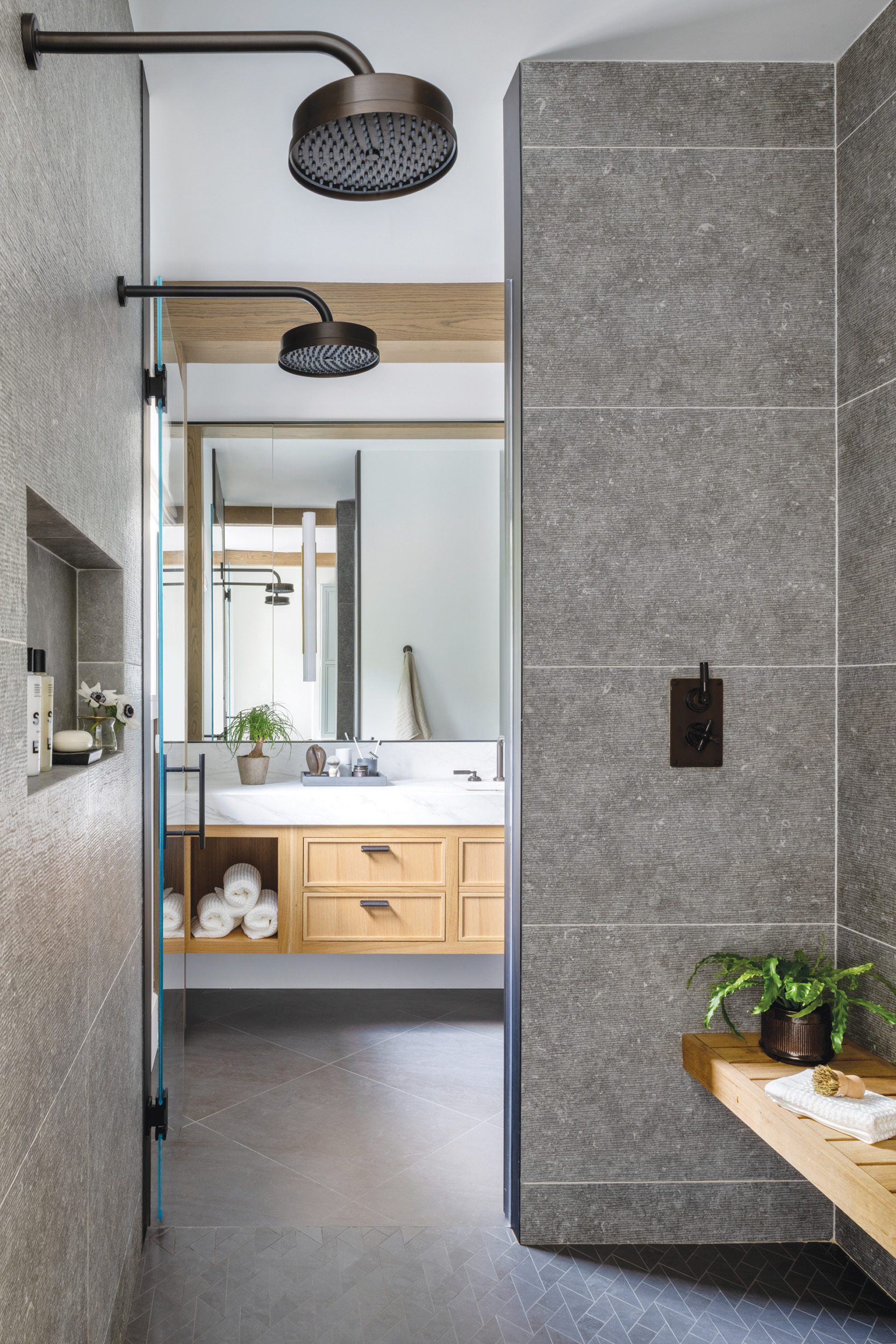 Slate floor and sleek tub in a modern bathroom designed by Interior Matter | Home and Design