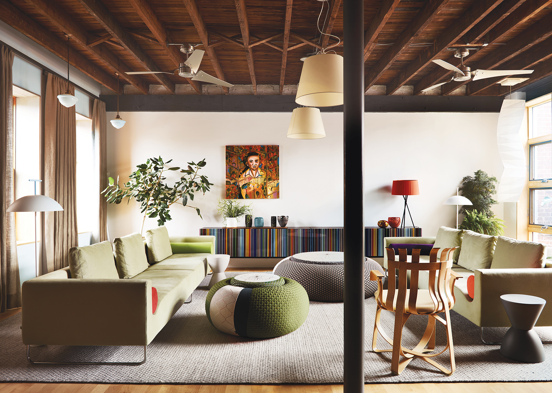 Second-floor living room with Bensen sofas, Barcode credenza, Frank Gehry chair, and burlap drapes by Everett Design | Home and Design Magazine