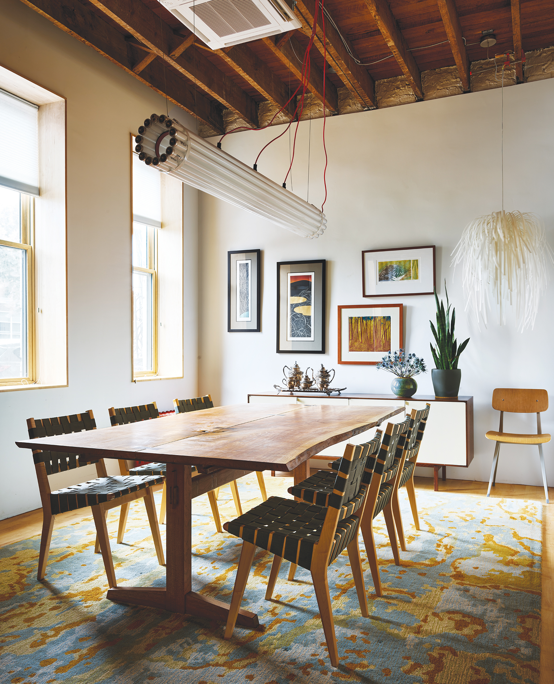 Space and dining room with Angela Adams rugs, Mira Nakashima table, and Castor LED fixture | Home and Design Magazine