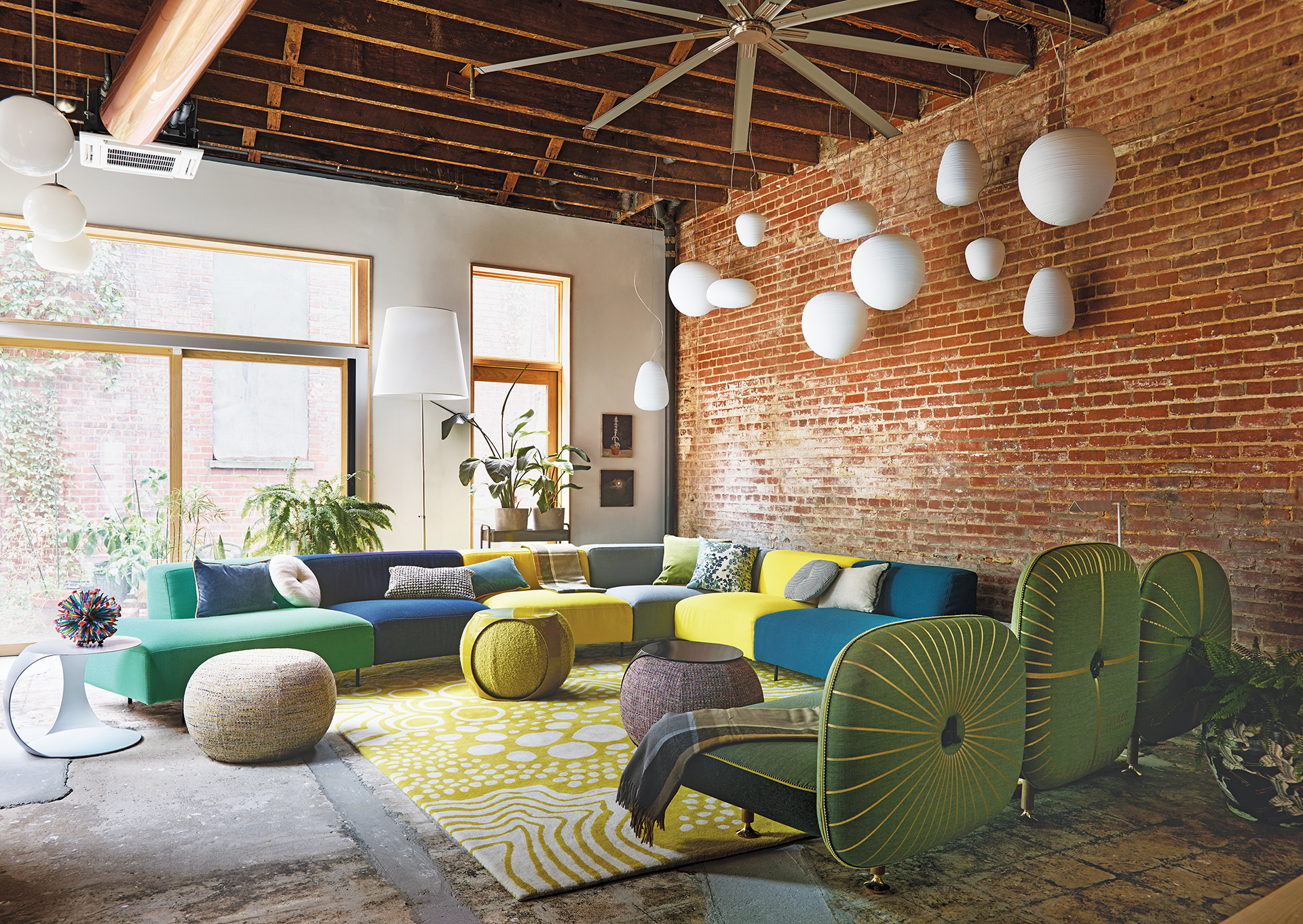 Family room with multi-hued Endless sectional by Bensen, Moroso sofa, and Foscarini lights | Home and Design Magazine