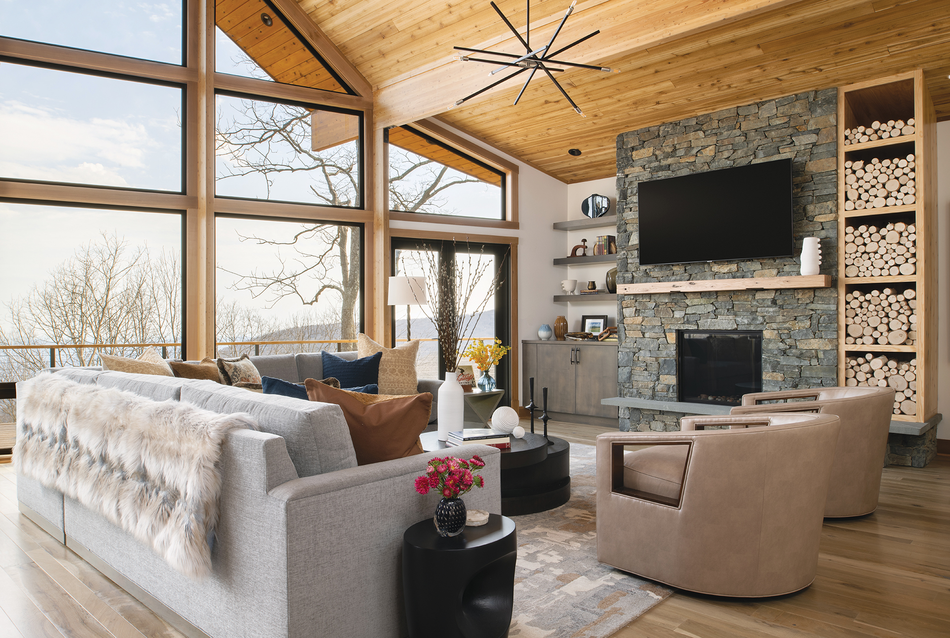 Sitting area with lowered cedar-paneled ceiling, sectional by TCS Designs, Hinkley Lighting chandelier, and Jaunty carpet | Home and Design Magazine