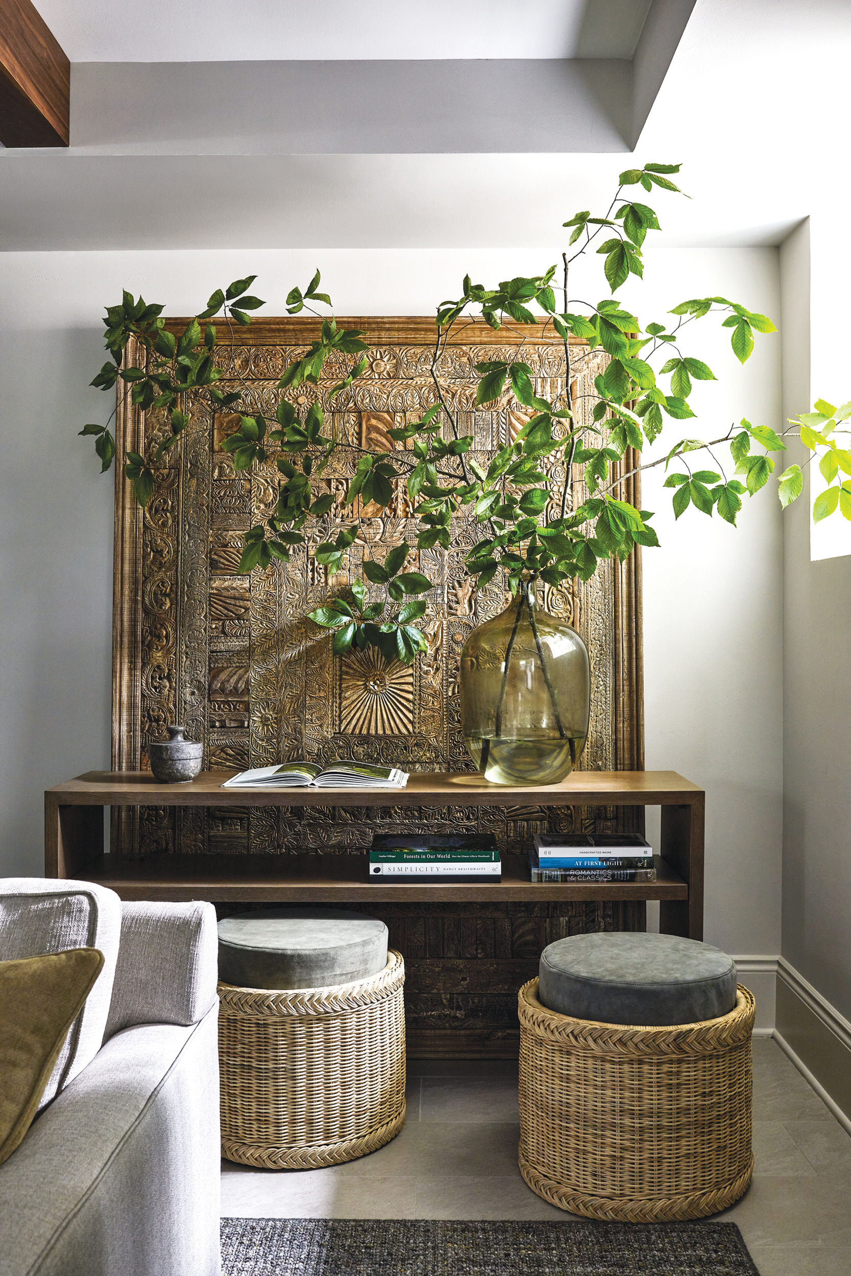 Lower-level hangout space with custom walnut console and carved-wood panel | Home and Design