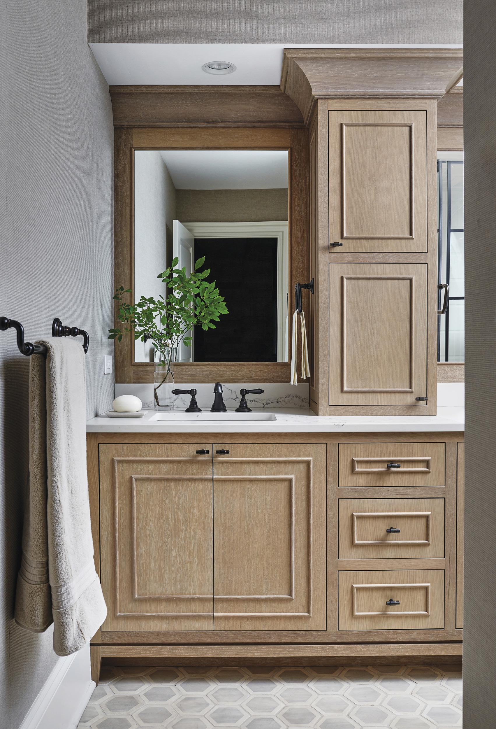 Bespoke light-stained cabinetry topped with marble-like Caesarstone in the bath | Home and Design