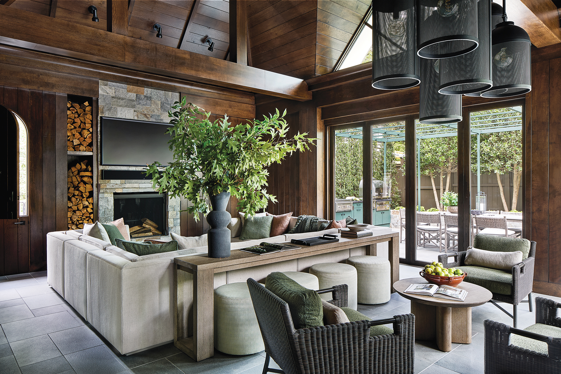Porch addition with custom Baker sectional in indoor-outdoor fabric for year-round movie nights | Home and Design