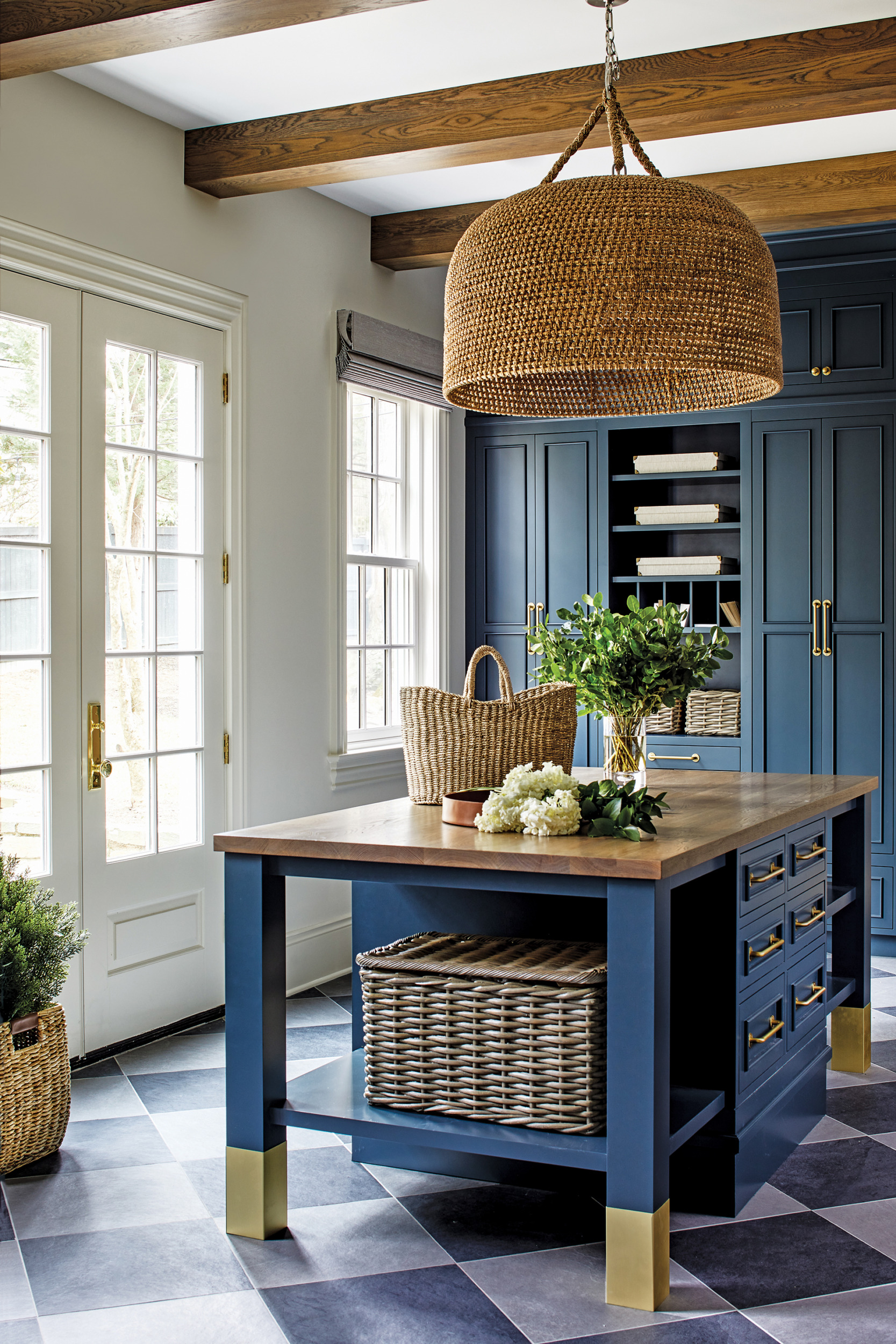 Mudroom with custom storage by Lyndon Heath Cabinetry and oversized rattan pendant from Palecek | Home and Design