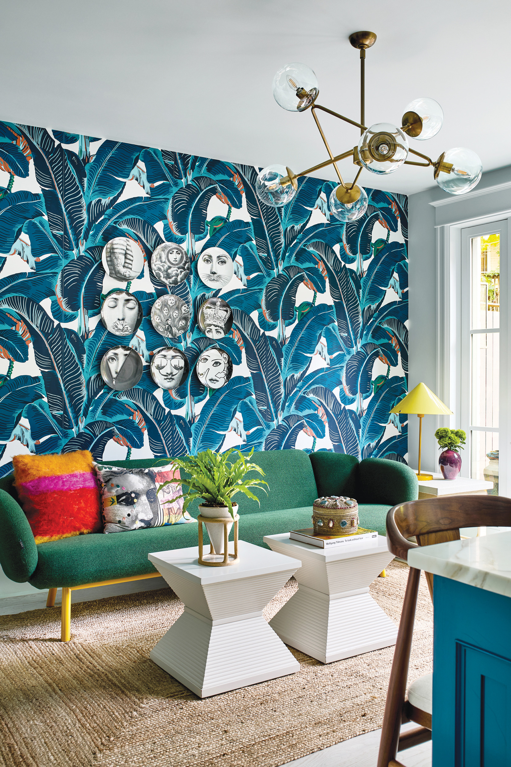 Sitting area with tropical CW Stockwell wallpaper, Artifort sofa by Tom Preston, and Chairish tables | Home and Design Magazine