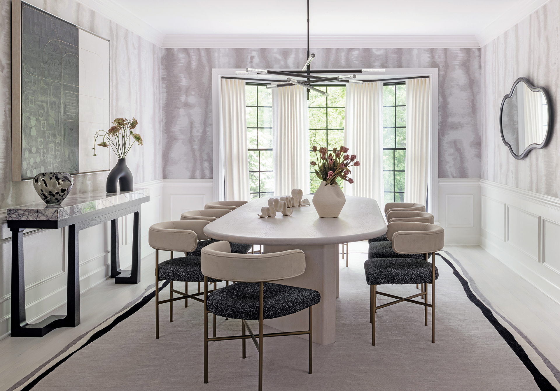 Dining room with wainscot, Holly Hunt wallpaper, designer table, and Art+Loom rug in coordinating floor color | Home and Design
