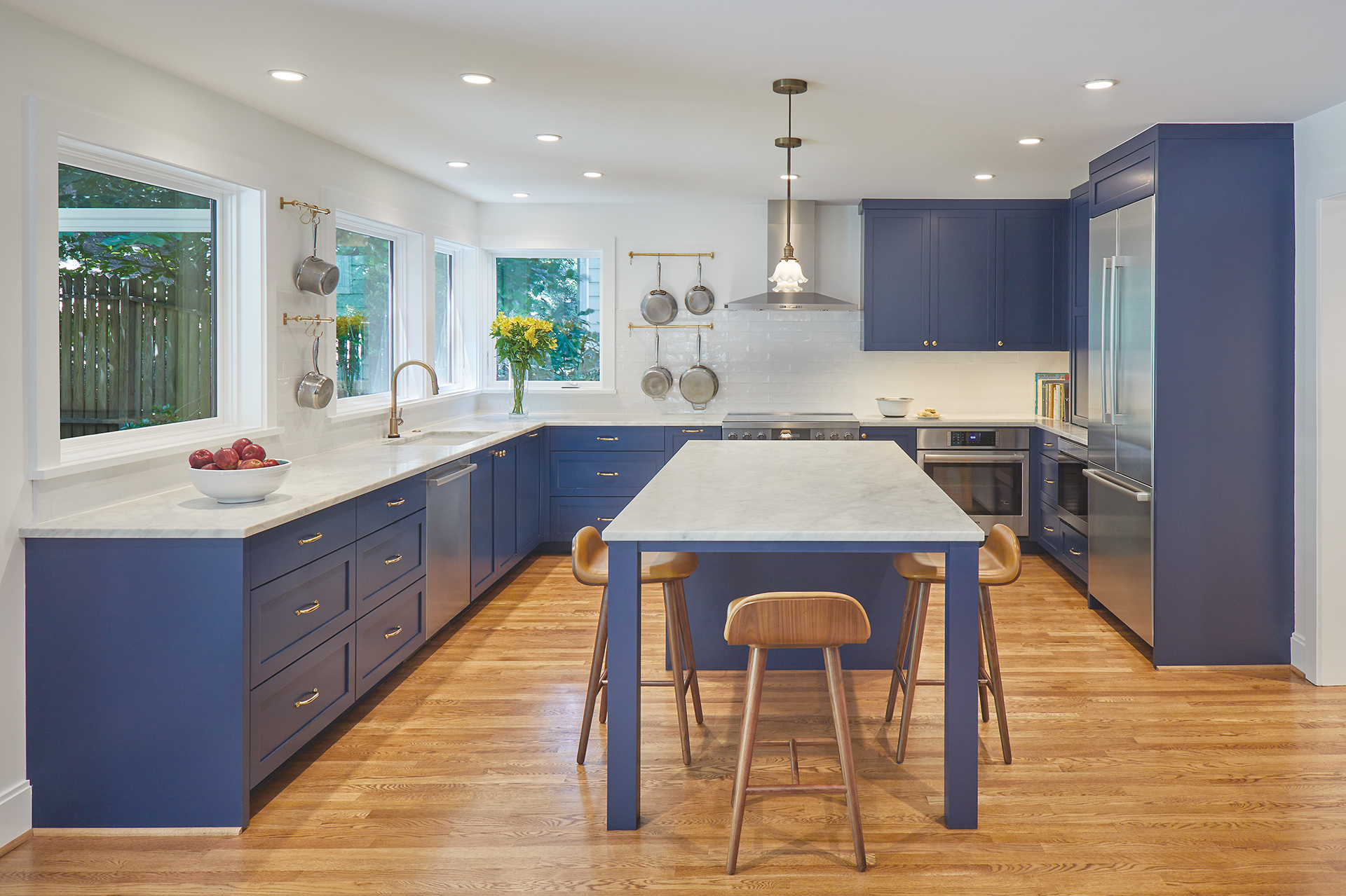 modern kitchen with blue cabinets and Calacatta Michelangelo marble counters