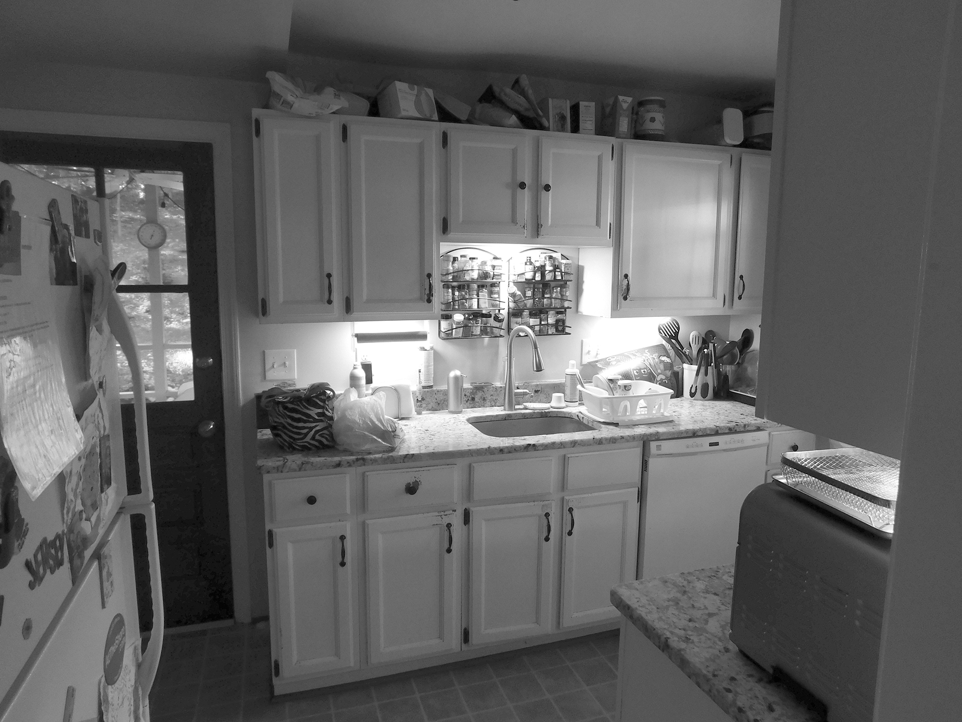 black and white before picture of an outdated kitchen