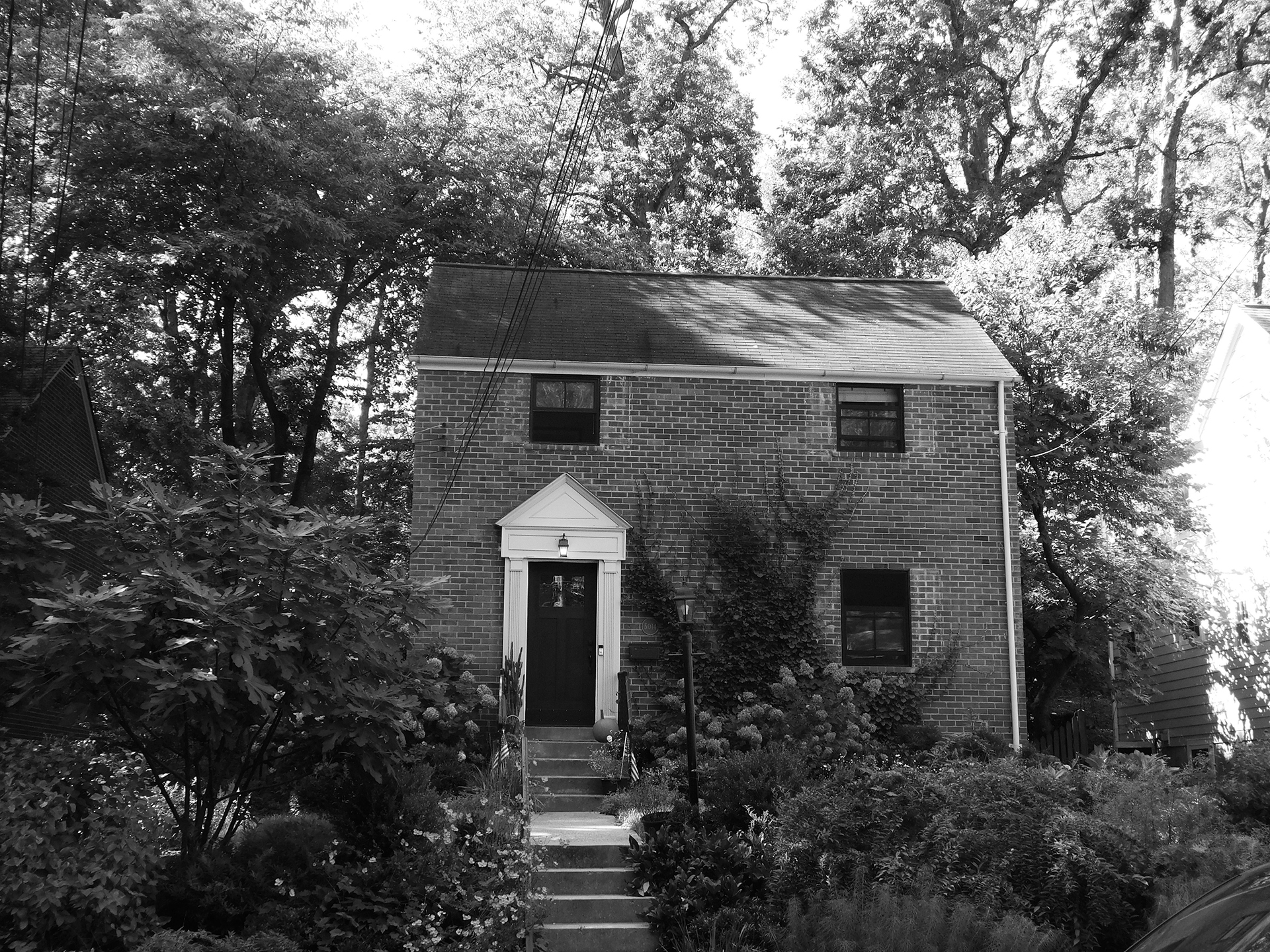 black and white before image of renovated brick colonial